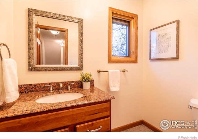 bathroom with toilet and vanity