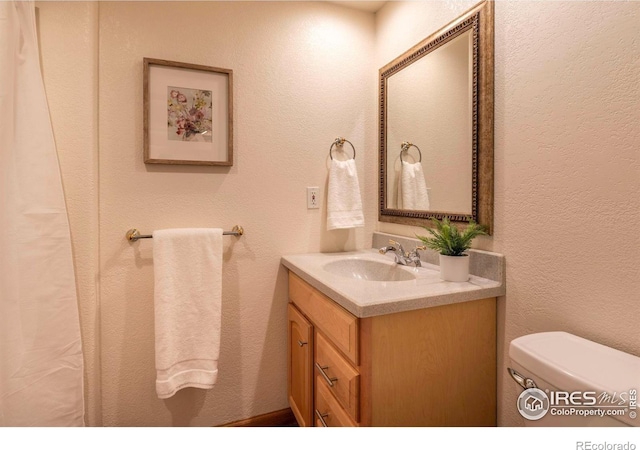 bathroom with toilet and vanity