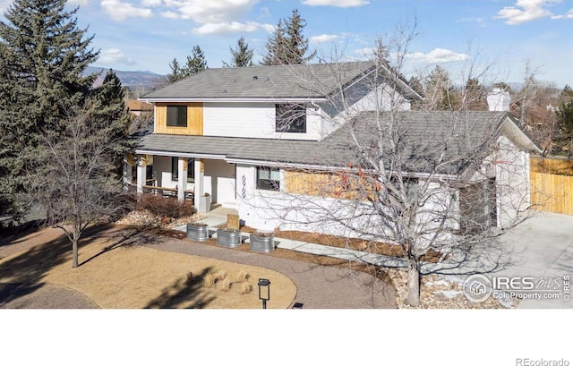 view of front of property with covered porch and central air condition unit