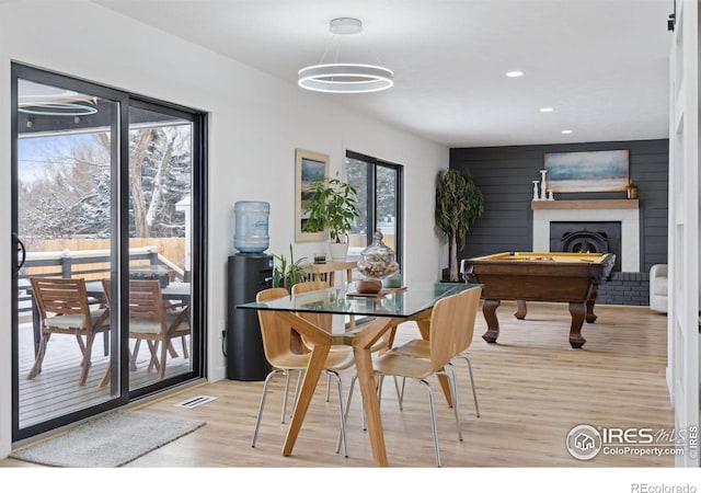 dining space with light hardwood / wood-style floors and billiards