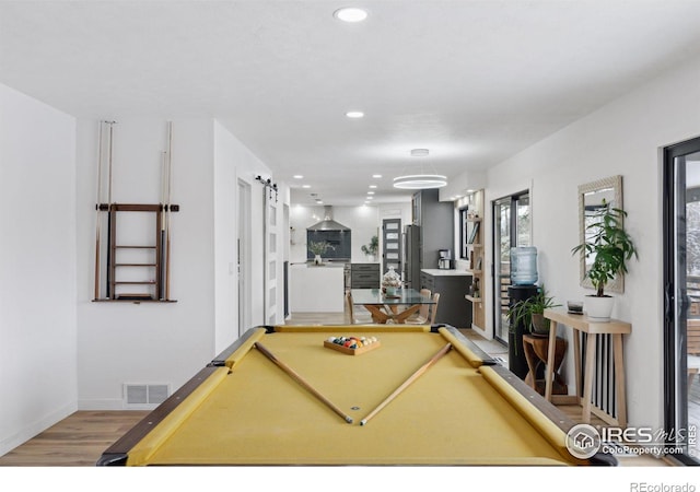 playroom featuring light wood finished floors, recessed lighting, pool table, visible vents, and a barn door