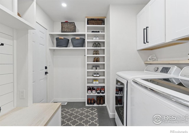 washroom with washer and clothes dryer, cabinet space, and recessed lighting