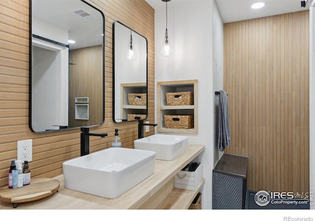 full bath with double vanity, visible vents, a sink, and recessed lighting