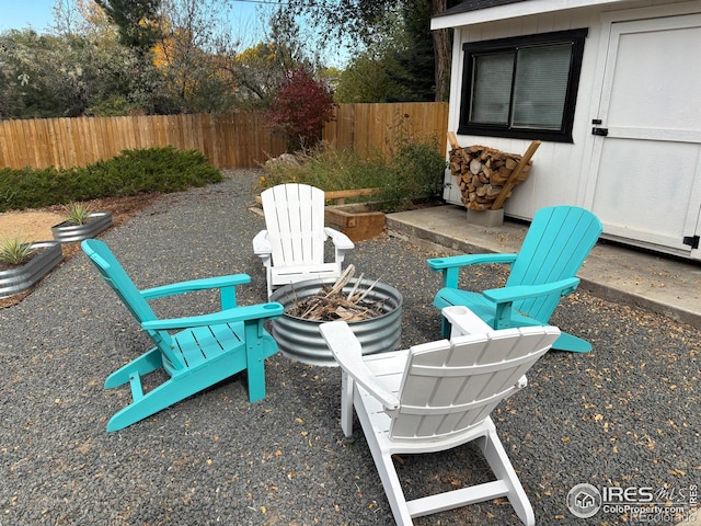 view of patio / terrace featuring a fire pit and fence