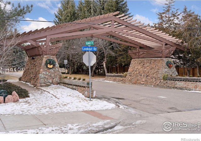 snow covered patio featuring a pergola