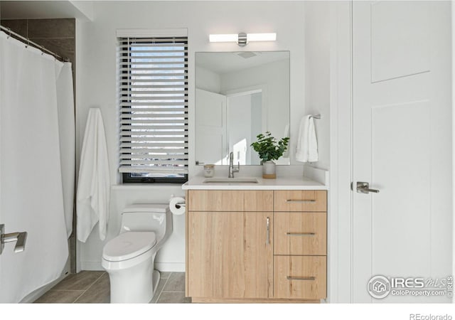 bathroom featuring vanity and toilet