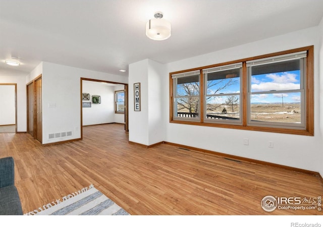 unfurnished living room featuring light hardwood / wood-style floors