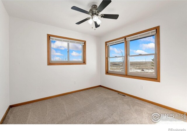 spare room featuring carpet floors and ceiling fan