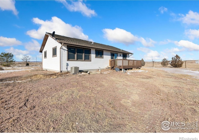 view of front of home with central AC unit and a deck