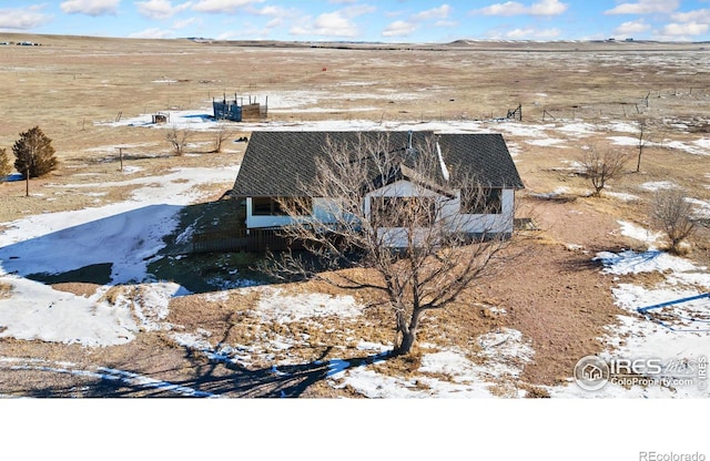 snowy aerial view featuring a rural view