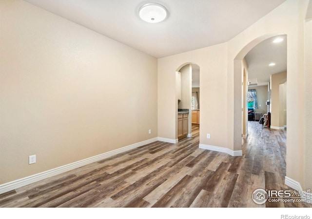 empty room featuring dark wood-type flooring