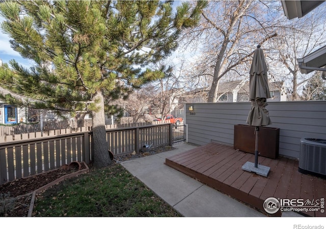 view of yard with cooling unit and a wooden deck