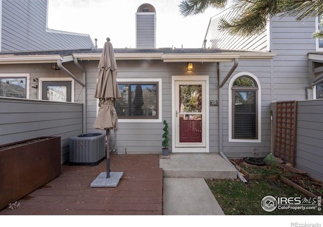 doorway to property featuring a deck and cooling unit