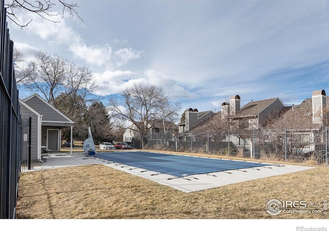 view of pool featuring a yard and a patio area