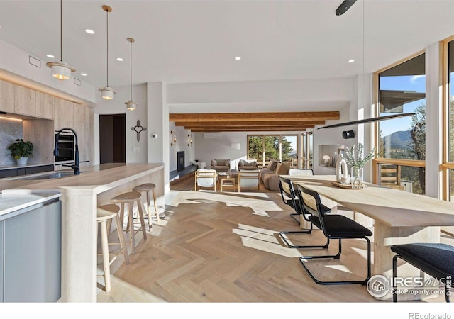 dining space with light parquet flooring, a mountain view, and sink