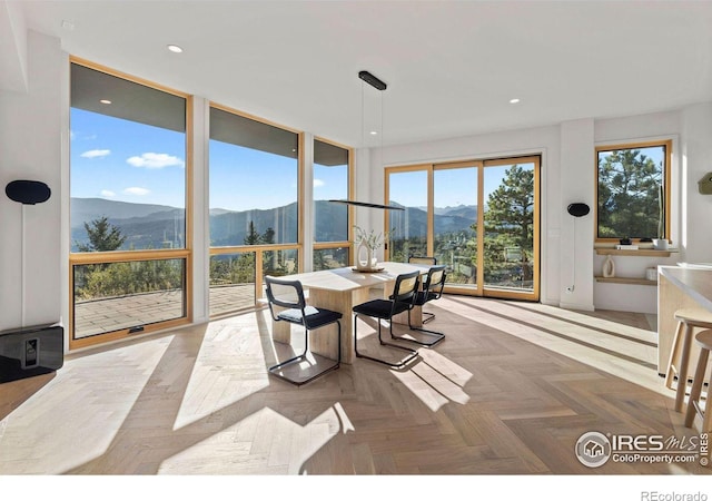 dining area with parquet floors and a mountain view