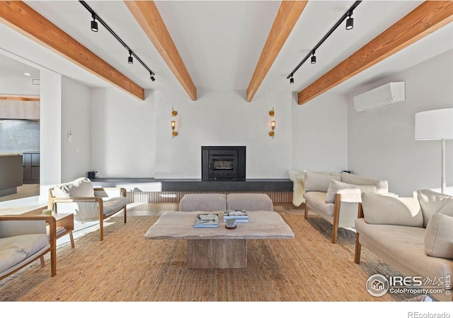 living room with track lighting, beam ceiling, and a wall unit AC