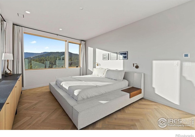 bedroom featuring a mountain view and light parquet floors