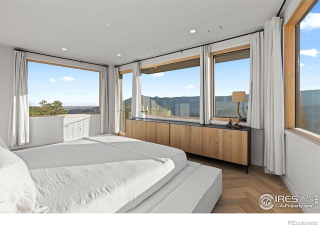 bedroom with a mountain view and parquet flooring