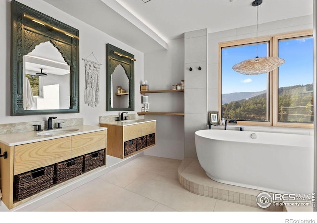 bathroom featuring vanity, a bath, a mountain view, and tile patterned flooring