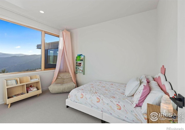 carpeted bedroom with a mountain view