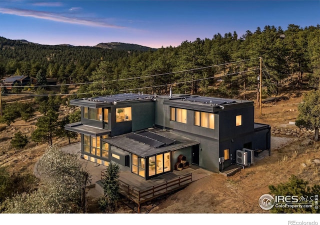 back house at dusk with a mountain view