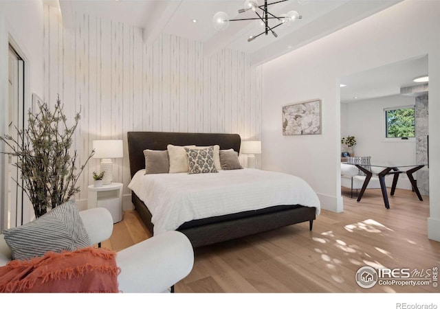 bedroom with an inviting chandelier, wooden walls, light hardwood / wood-style flooring, and beamed ceiling