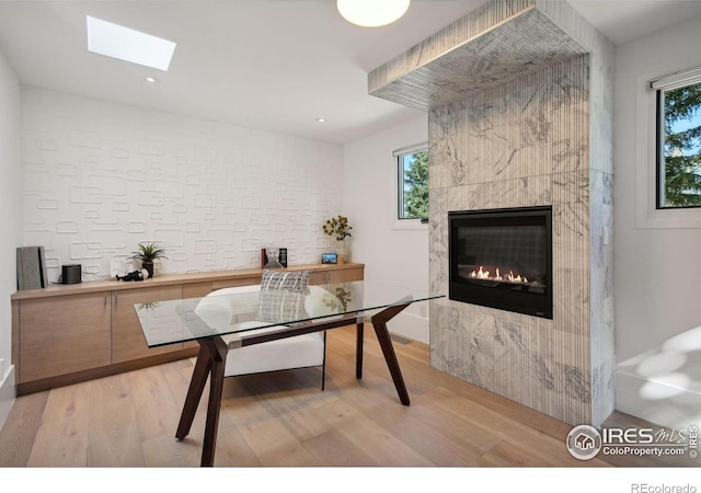 dining space featuring light hardwood / wood-style floors and a fireplace