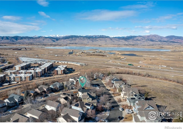 drone / aerial view with a water and mountain view