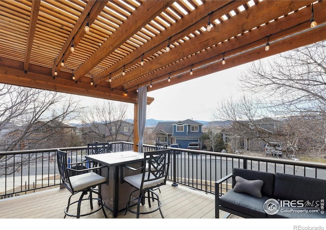 deck with a residential view, outdoor dining space, and a pergola