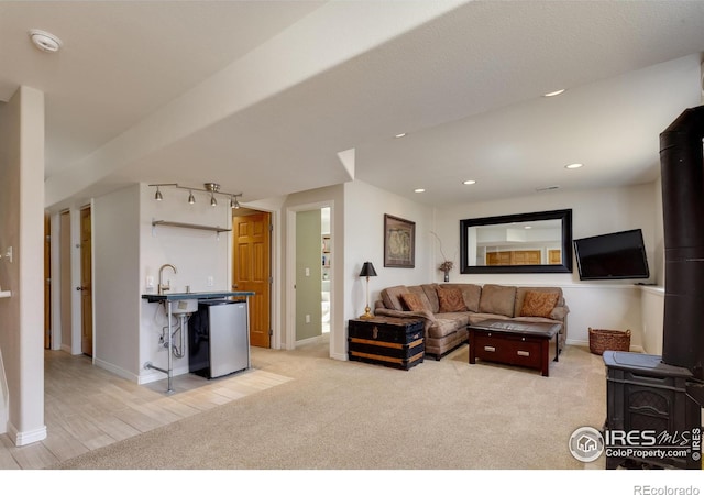 living area with recessed lighting, baseboards, and light carpet