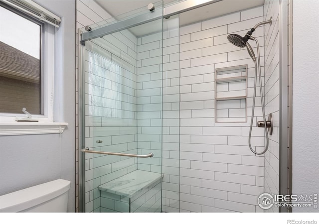 full bath with a shower stall and toilet