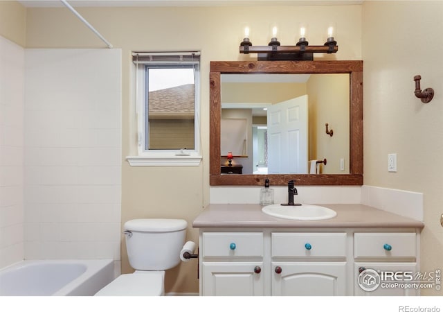 bathroom with bathing tub / shower combination, toilet, and vanity