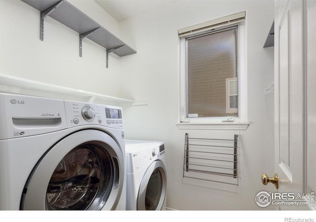 clothes washing area with laundry area and washing machine and clothes dryer