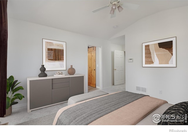 bedroom with vaulted ceiling, light colored carpet, visible vents, and ceiling fan