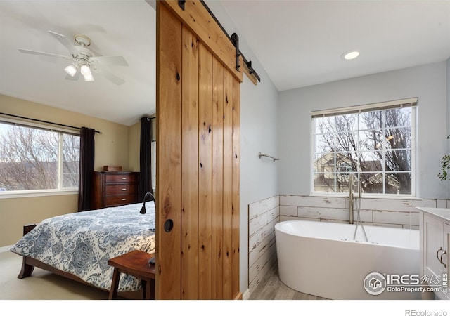 full bathroom featuring lofted ceiling, a freestanding tub, and ceiling fan