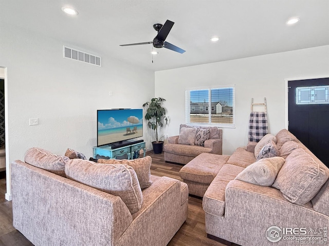 living room with ceiling fan and dark hardwood / wood-style flooring