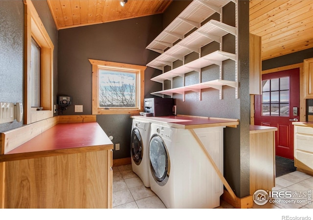 washroom with wood ceiling, washer and clothes dryer, and light tile patterned flooring