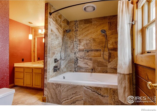 bathroom featuring vanity, tile patterned flooring, and shower / bath combo with shower curtain