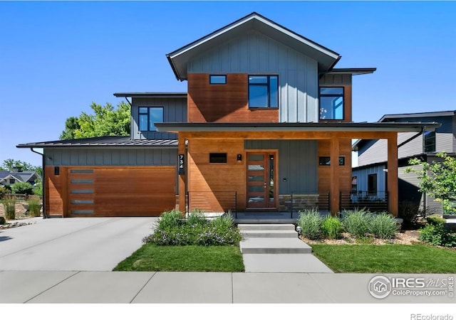 contemporary home featuring a porch and a garage