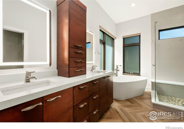 bathroom with vanity, parquet floors, and plus walk in shower