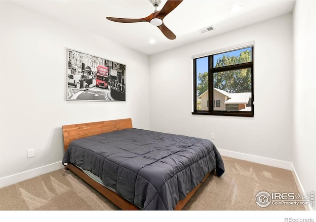 bedroom with ceiling fan and light carpet