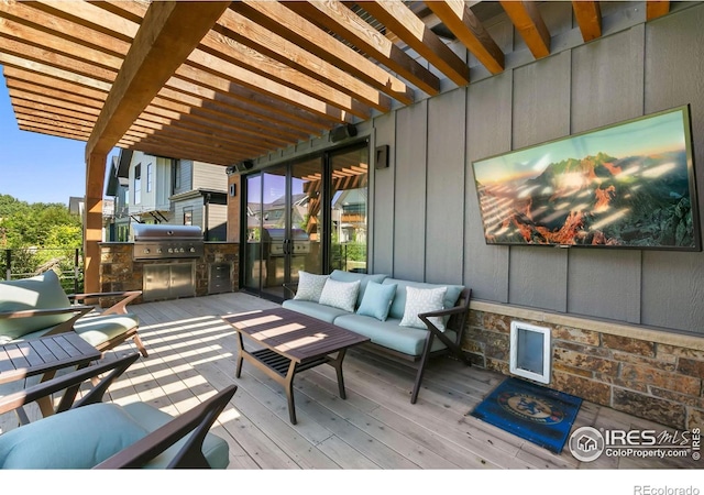 deck with a pergola, a grill, an outdoor kitchen, and an outdoor living space