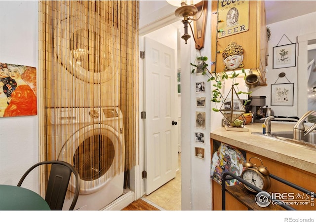 washroom with sink and washer / dryer