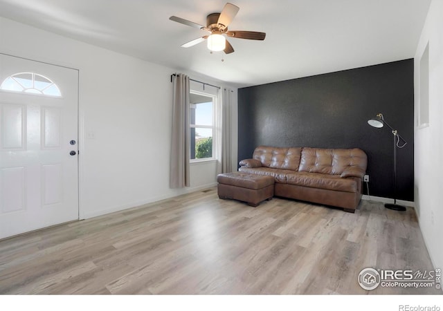 living room with ceiling fan and light hardwood / wood-style floors