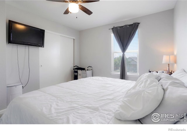 bedroom with ceiling fan and a closet