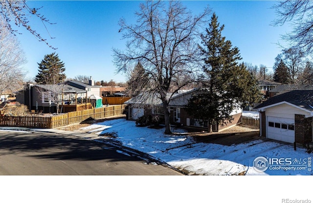 view of front of property with a garage and an outbuilding