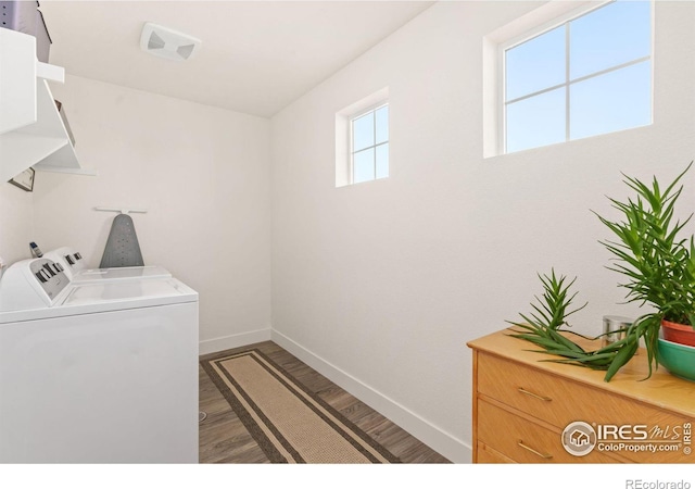 washroom with washing machine and clothes dryer and wood-type flooring