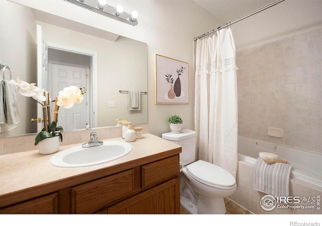 full bathroom with toilet, shower / bath combination with curtain, and vanity