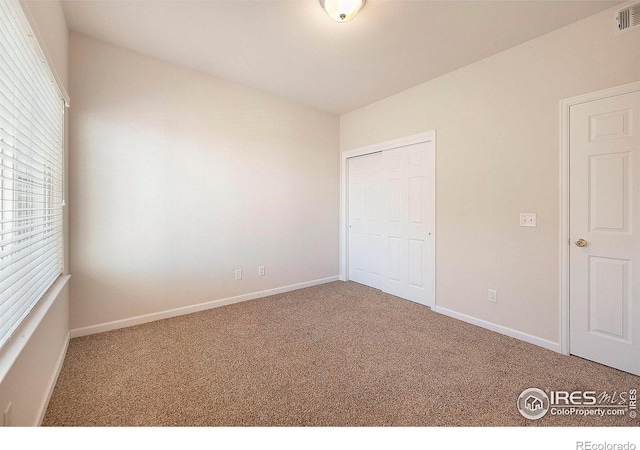 unfurnished bedroom featuring a closet and carpet